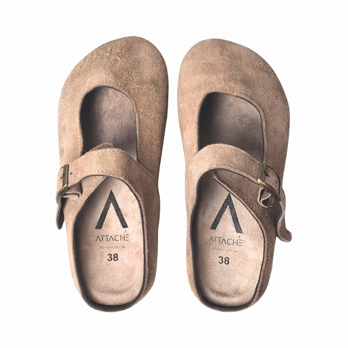 Attache Bags Merry Jane clogs in nude suede leather with an adjustable buckle strap and rounded toe profile.