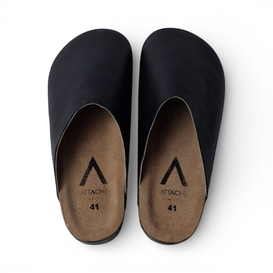Attache Bags black grain leather slip-on mules with cushioned leather footbed and durable rubber outsole.